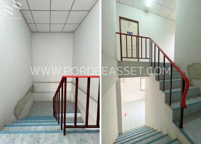 Staircase in a building with tiled floor and red handrails