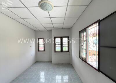 Empty bedroom with windows and tiled floor