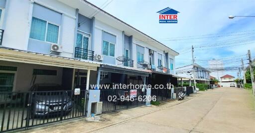 Exterior of a townhouse building on a street