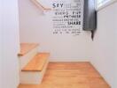 Well-lit staircase with wooden steps and motivational wall art