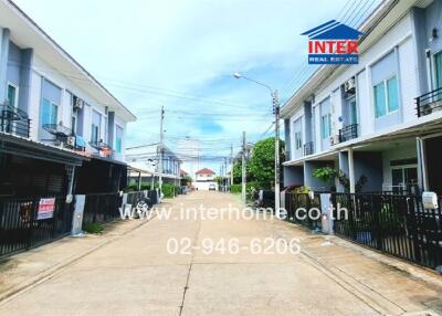 Exterior view of residential buildings on either side of a street