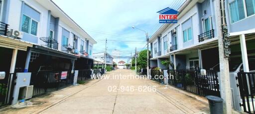 Exterior view of residential buildings on either side of a street