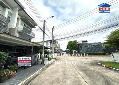 Street view of residential area with houses and a driveway