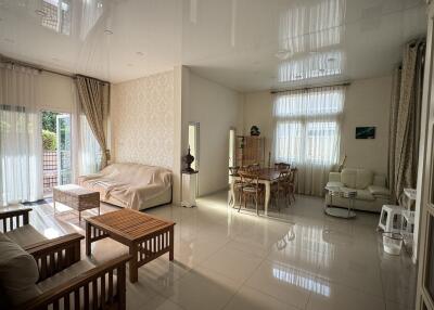 Spacious living room with modern decor and ample natural light