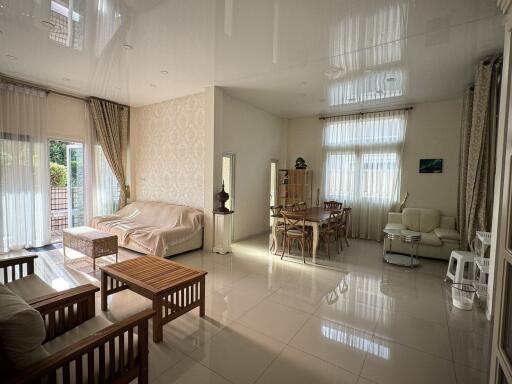 Spacious living room with modern decor and ample natural light