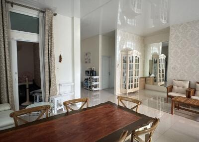 spacious dining area with wooden table and neutral tones