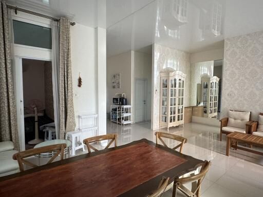 spacious dining area with wooden table and neutral tones