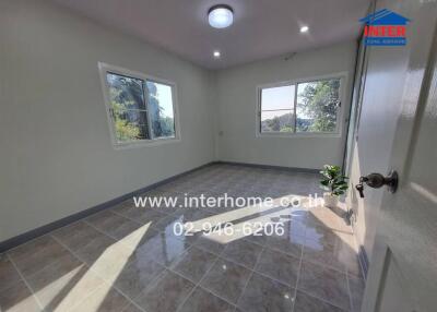 Bright and clean empty room with tiled floors and large windows