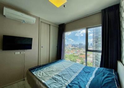 Bedroom with large window and city view