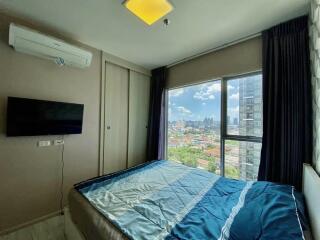 Bedroom with large window and city view