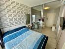 Modern bedroom with geometric wallpaper, large mirror, sliding glass door, and blue bedspread