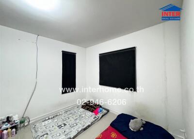 Bedroom with simple bedding and black-out curtains