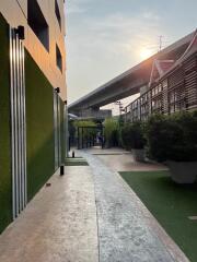 Pathway alongside modern building with greenery