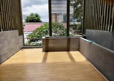 Spacious balcony with wooden flooring and modern railings