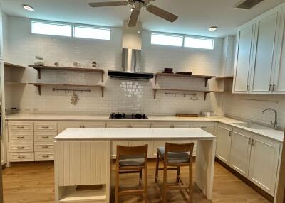 Modern white kitchen with island and chairs