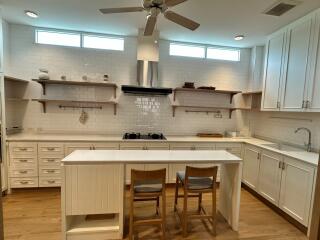 Modern white kitchen with island and chairs