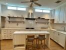 Modern white kitchen with island and chairs