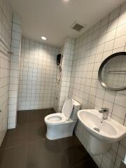 Modern bathroom with white tiled walls and fixtures