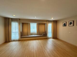 Spacious living room with large windows and built-in seating