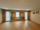 Spacious living room with large windows and built-in seating