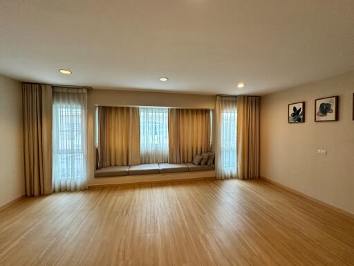 Spacious living room with large windows and built-in seating