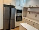 Modern kitchen with built-in appliances and wooden flooring