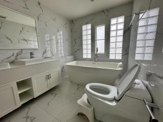 modern bathroom with bathtub and large windows