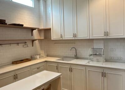 Modern white kitchen with island and wooden floor