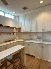 Modern white kitchen with island and wooden floor