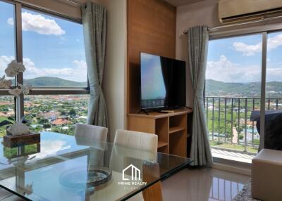 Modern living room with large windows and mounted TV