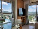 Modern living room with large windows and mounted TV