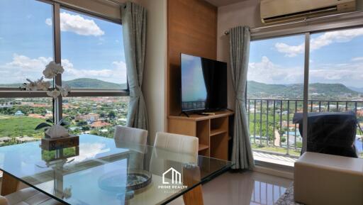 Modern living room with large windows and mounted TV