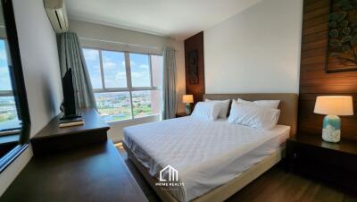 Bedroom with a large window and a view