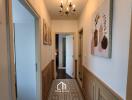 Hallway with wall art, chandelier, and doorways