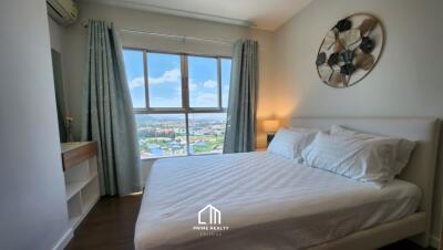 Cozy modern bedroom with a large window and city view