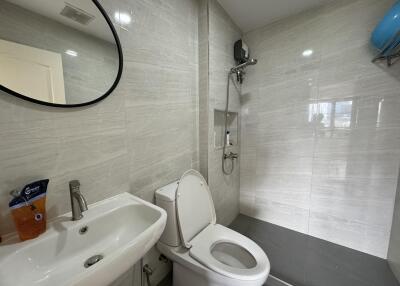 Modern bathroom with lavabo, toilet, and shower