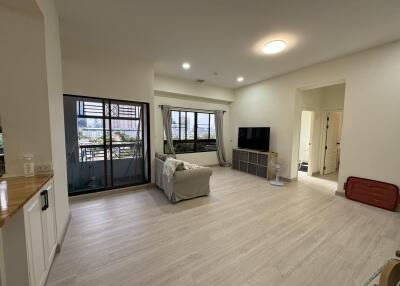 Spacious living room with large windows and balcony