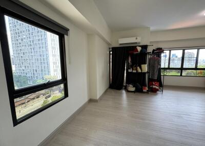 Spacious bedroom with large windows and city view