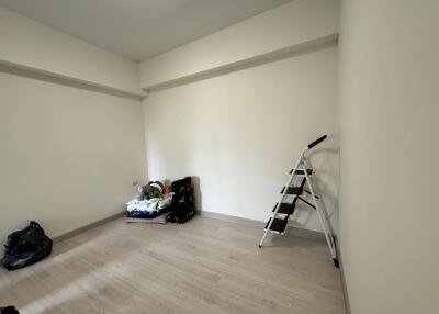 Empty bedroom with ladder and some belongings