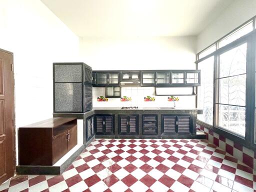 Modern kitchen with dark cabinets and checkered floor