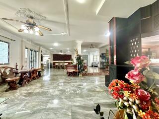 Spacious living room with marble flooring and floral decorations