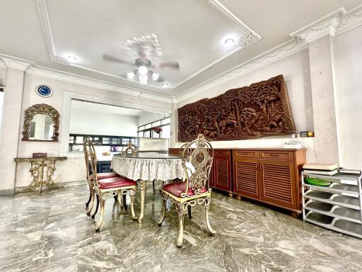 Elegant dining room with ornate furniture and wall art