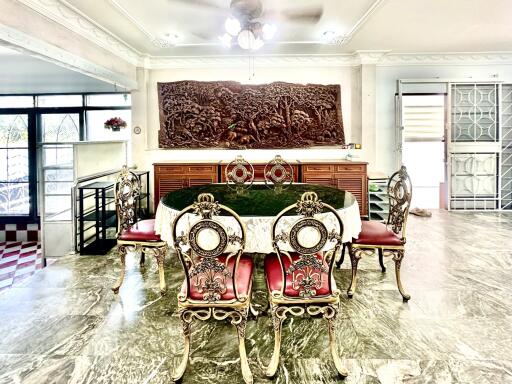 Elegant dining room with ornate furniture and large wooden wall carving