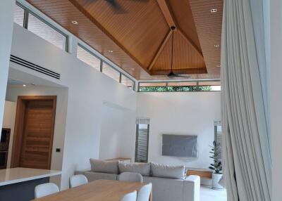 Modern living room with vaulted wooden ceiling and ceiling fans