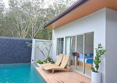 Outdoor Pool Area with Seating and Adjacent Bedroom