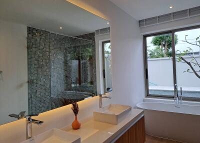 Modern bathroom with double sinks and bathtub