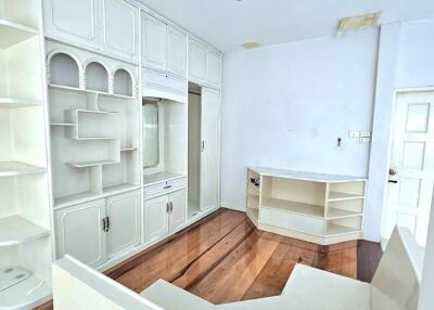 Bright living room with built-in cabinets and wooden floor