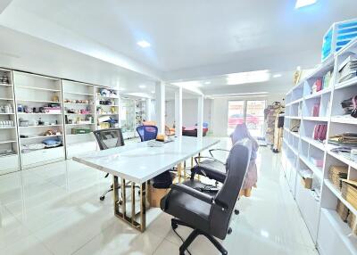 Spacious and well-lit office area with shelves and seating