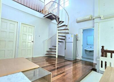 Living area with staircase and loft