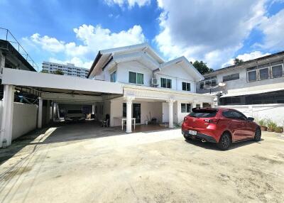 Beautiful two-story residential white house with carport